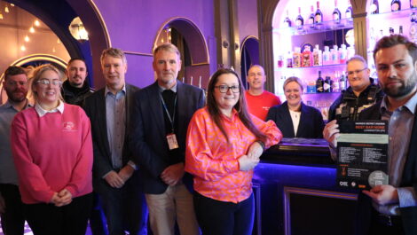 Community safety partners hold up Best Bar None signs outside The Terrace restaurant.